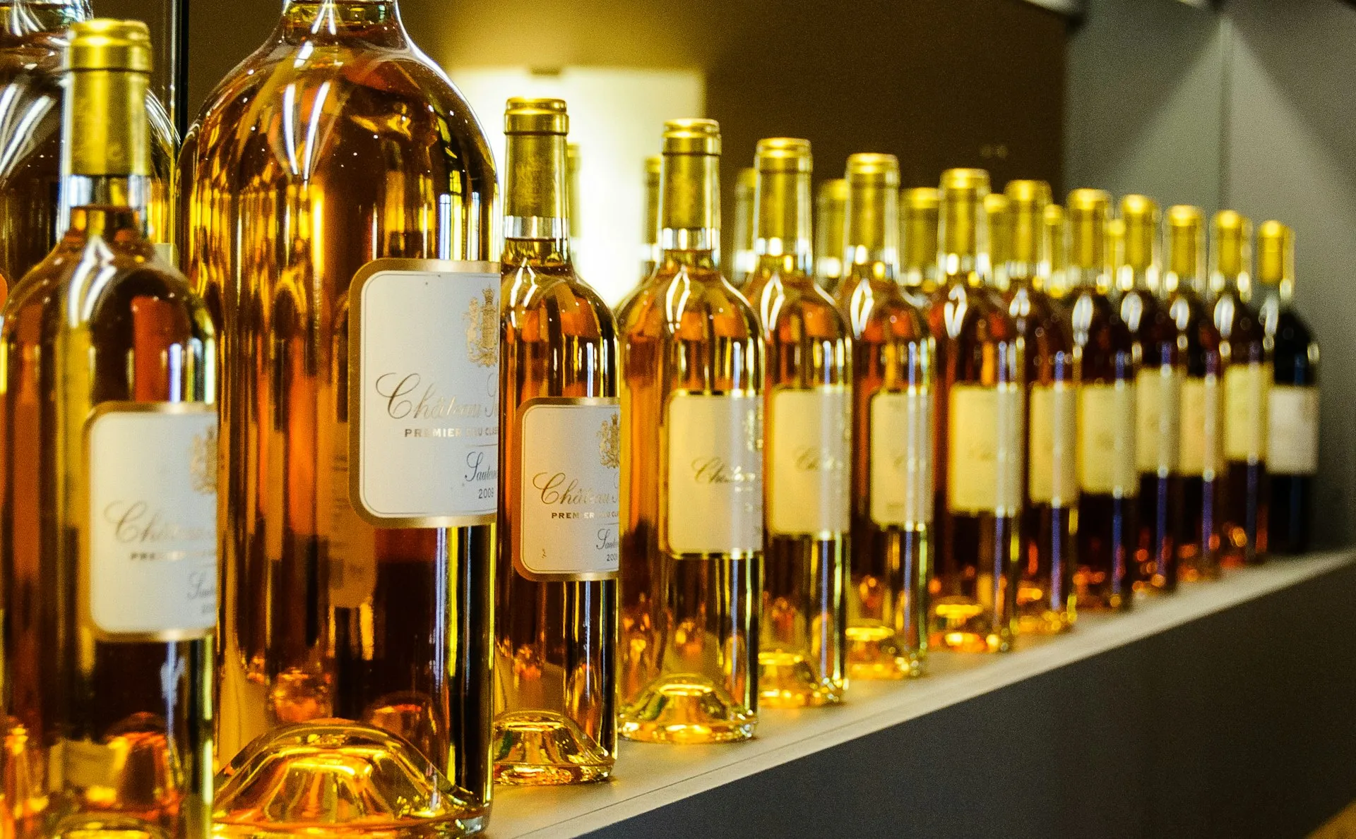 Flasker med gylden vin på en hylde